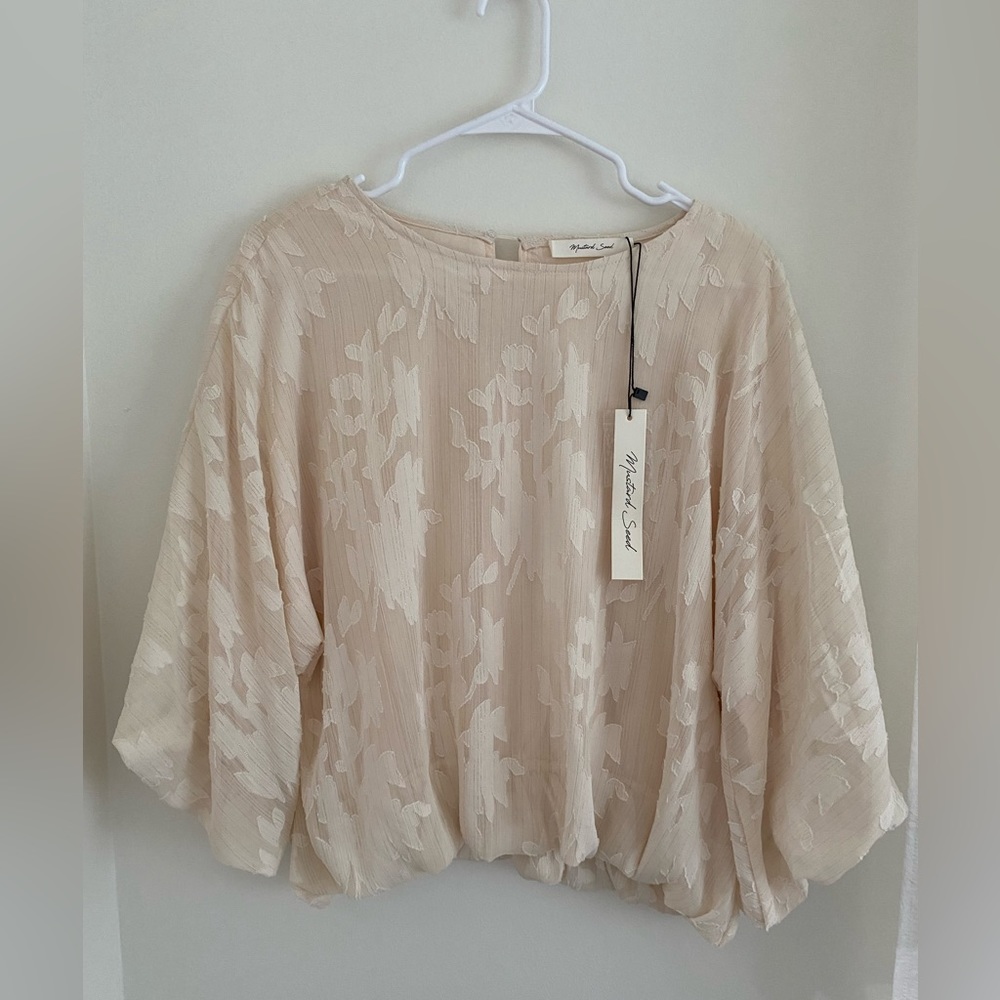 Peach colored, puff sleeve blouse